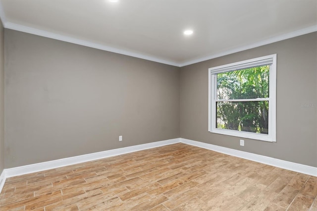 unfurnished room with light hardwood / wood-style floors and crown molding