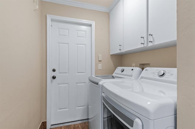 washroom with cabinets, dark hardwood / wood-style flooring, washer and clothes dryer, and crown molding