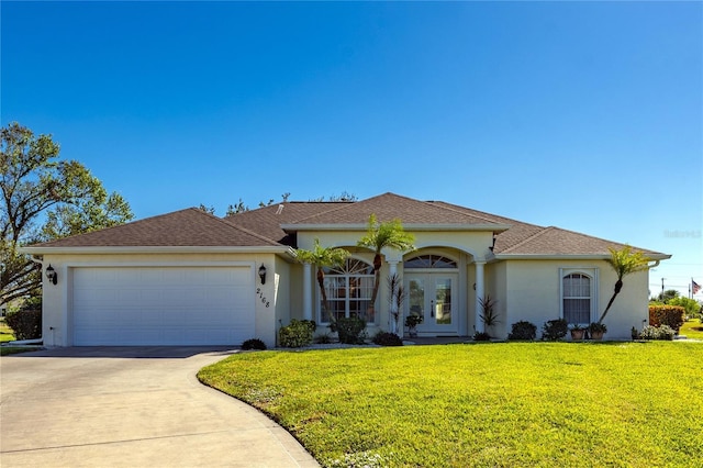 view of front of property with a garage and a front lawn