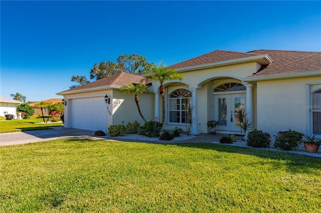 view of front of property with french doors, a front lawn, and a garage