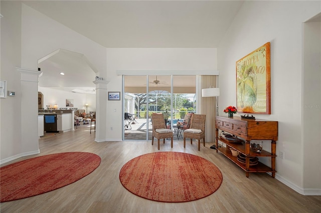 living area with light hardwood / wood-style floors and decorative columns