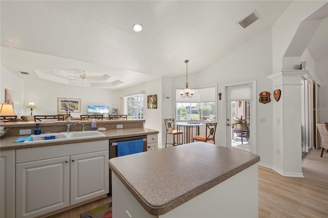 kitchen with dishwasher, a center island, sink, light hardwood / wood-style flooring, and ceiling fan