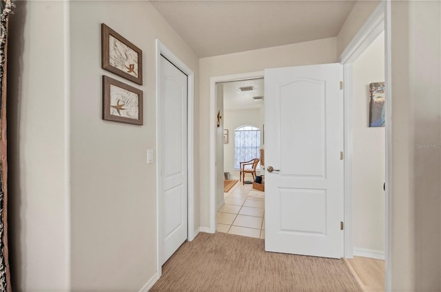 corridor with light tile patterned floors