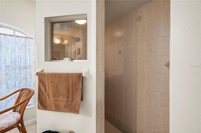 bathroom with a tile shower