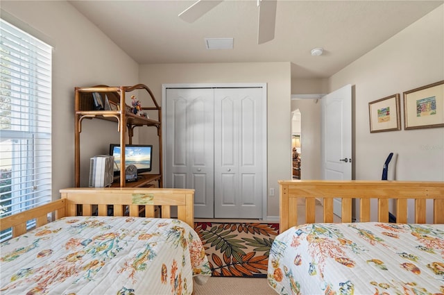 bedroom with ceiling fan and a closet