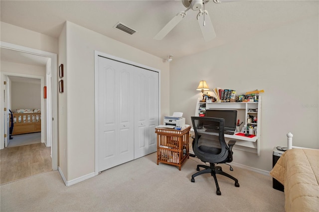 office featuring ceiling fan and light carpet