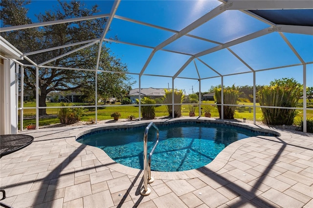 view of pool with glass enclosure and a patio