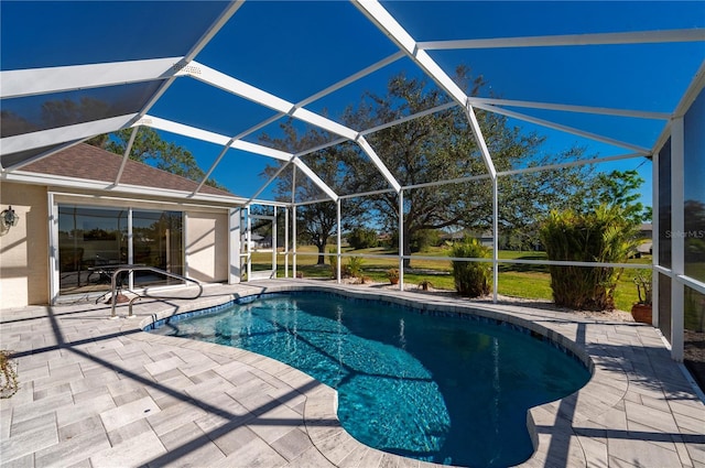 view of swimming pool with a lanai and a patio area