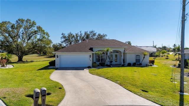 view of front of house featuring french doors, a front yard, and a garage