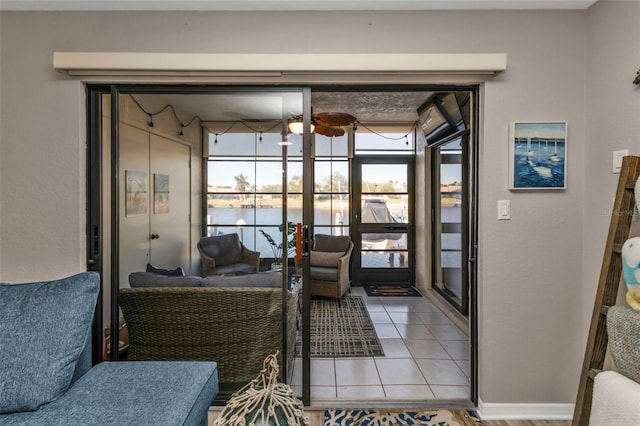 tiled living room with french doors and a water view