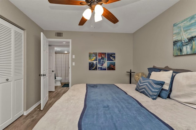 bedroom with ceiling fan, a closet, ensuite bathroom, and dark hardwood / wood-style floors