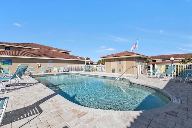 view of pool with an outbuilding and a patio area