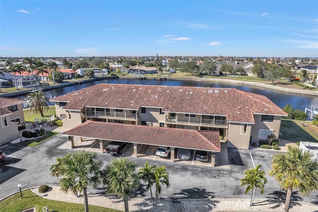 birds eye view of property with a water view and a residential view