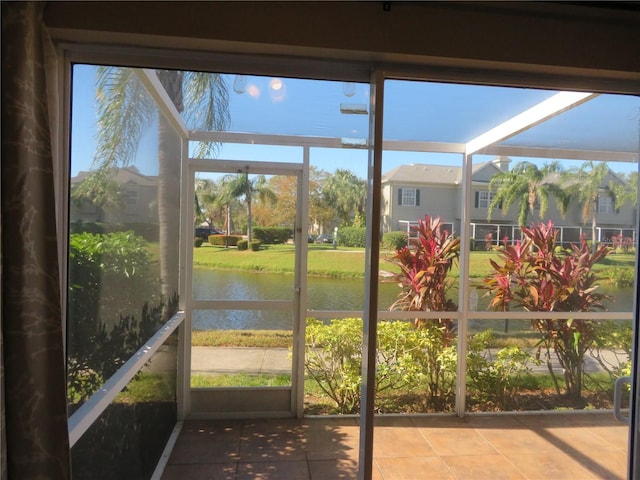 unfurnished sunroom featuring a water view