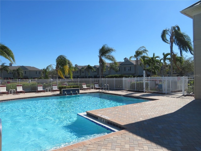 view of pool with pool water feature and a patio area