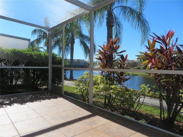 unfurnished sunroom with a water view