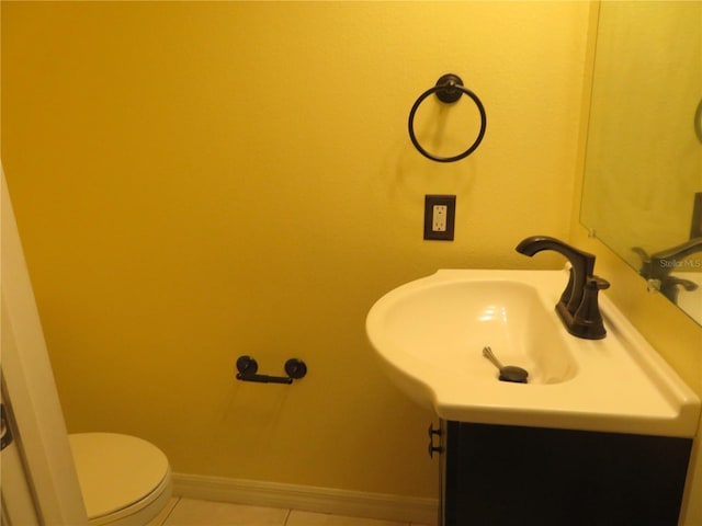 bathroom with tile patterned floors, vanity, and toilet