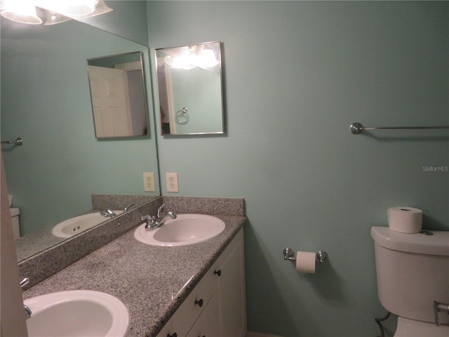 bathroom featuring toilet and vanity