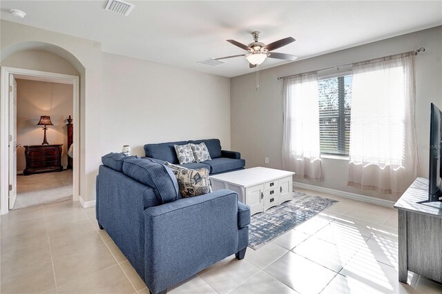 living room featuring light tile patterned floors and ceiling fan