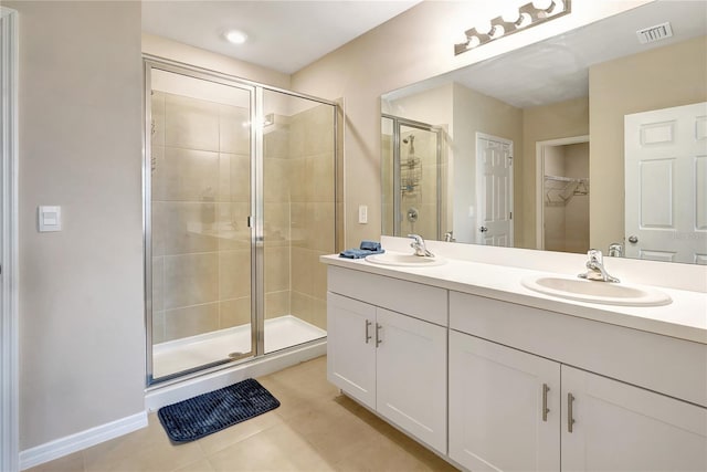 bathroom featuring tile patterned floors, vanity, and walk in shower