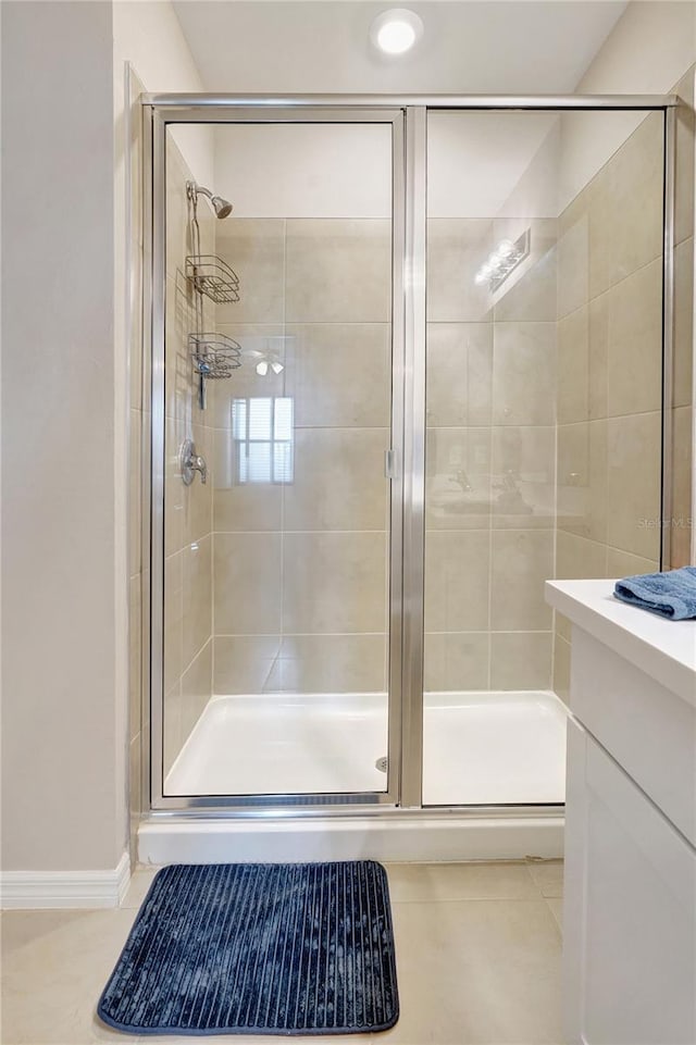 bathroom with tile patterned flooring and a shower with door