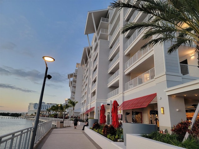 outdoor building at dusk featuring a water view