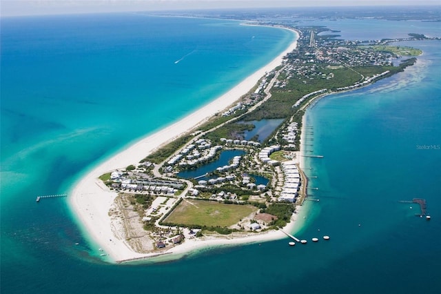 birds eye view of property with a beach view and a water view