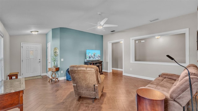 living room featuring ceiling fan, lofted ceiling, and parquet flooring