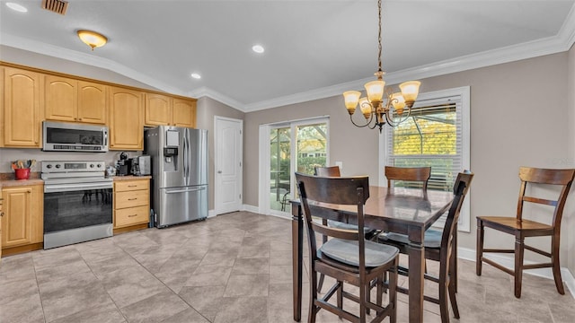 kitchen featuring a notable chandelier, crown molding, pendant lighting, lofted ceiling, and appliances with stainless steel finishes