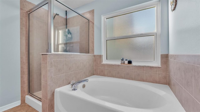 bathroom with separate shower and tub