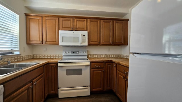 2000 Forrest Nelson Blvd Unit C8, Port Charlotte, FL 33952 - kitchen featuring white appliances, a sink, dark wood-style floors, brown cabinetry, and wooden counters