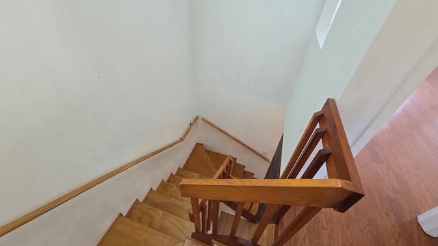 stairs with hardwood / wood-style floors