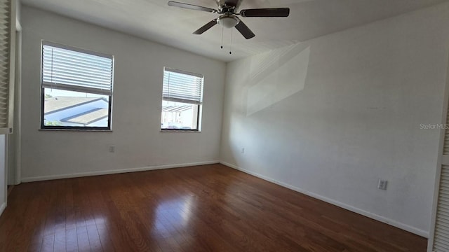 empty room featuring dark hardwood / wood-style flooring and ceiling fan