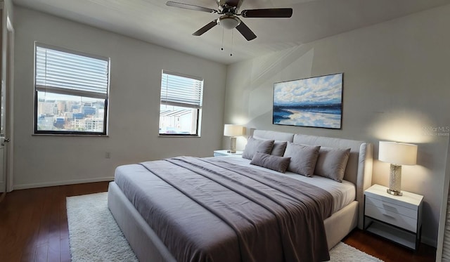 2000 Forrest Nelson Blvd Unit C8, Port Charlotte, FL 33952 - bedroom with dark wood-style floors, baseboards, and a ceiling fan