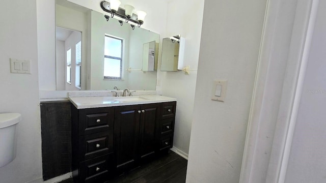 bathroom featuring vanity and toilet