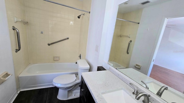 full bathroom with wood-type flooring, vanity, toilet, and tiled shower / bath