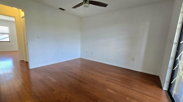 unfurnished room featuring dark hardwood / wood-style floors and ceiling fan