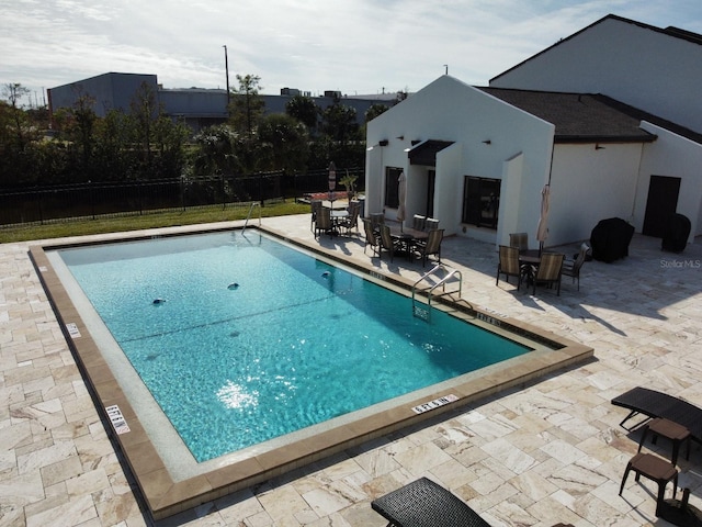 view of swimming pool with a patio