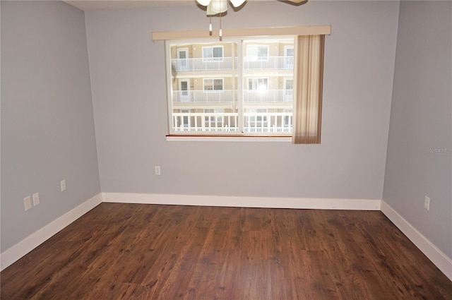 spare room featuring ceiling fan, baseboards, and wood finished floors