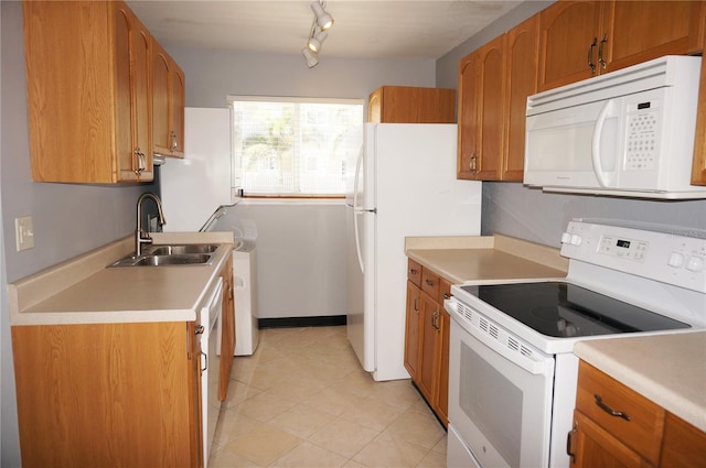 kitchen with light countertops, white appliances, a sink, and brown cabinets