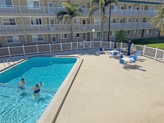 pool featuring a patio area and fence