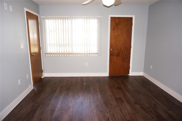 spare room with a ceiling fan, baseboards, and wood finished floors