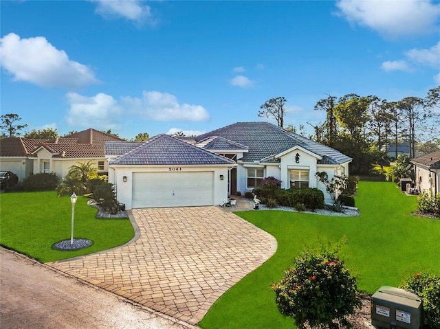 view of front facade with a front yard and a garage