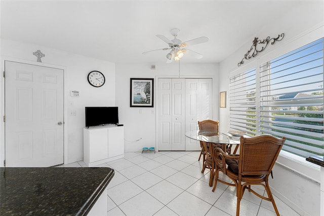 tiled dining room with ceiling fan