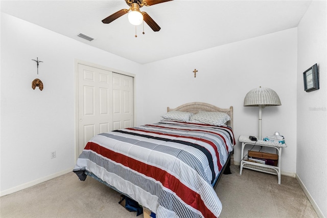 carpeted bedroom featuring a closet and ceiling fan