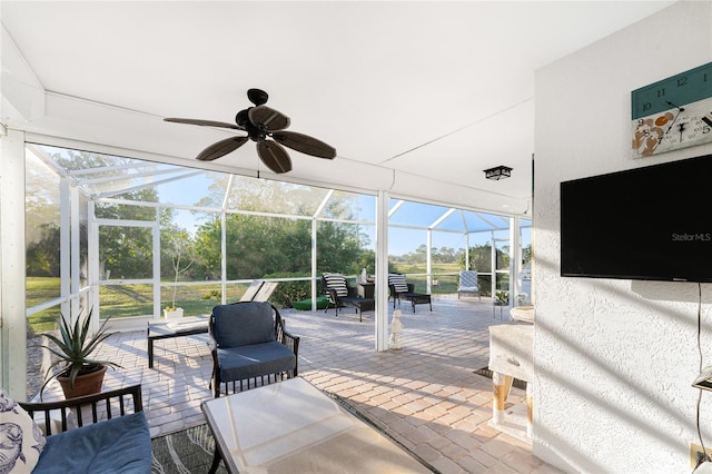 sunroom / solarium featuring ceiling fan