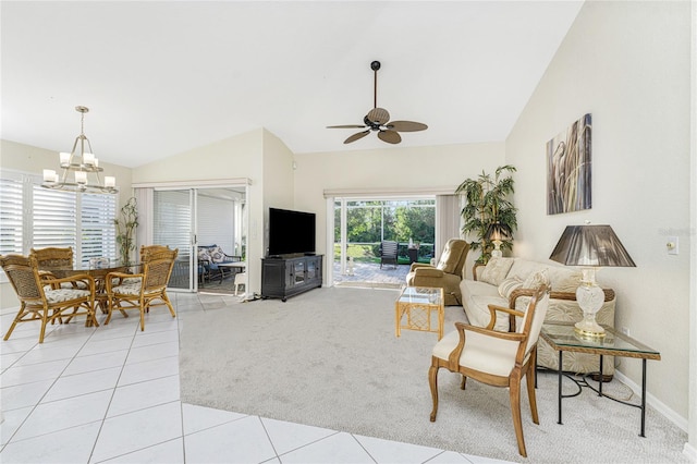 tiled living room with ceiling fan with notable chandelier and lofted ceiling