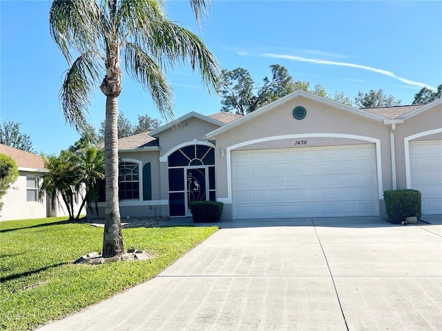 ranch-style home with a garage and a front yard