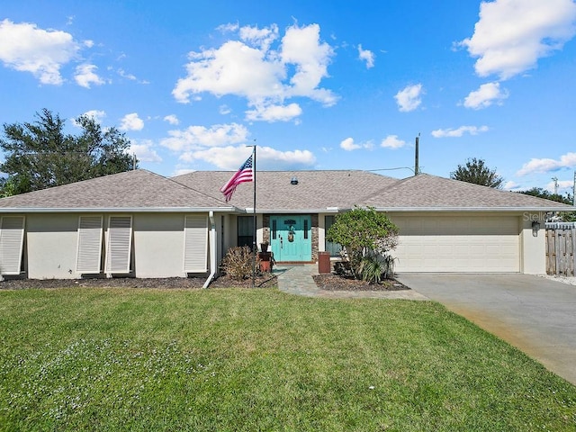 single story home with a front yard and a garage