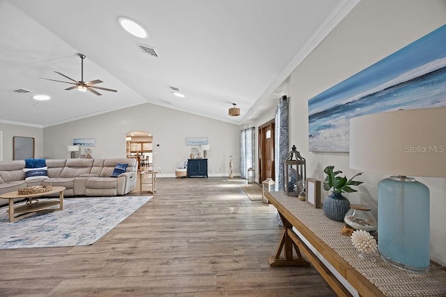 living room with ceiling fan, ornamental molding, lofted ceiling, and hardwood / wood-style flooring